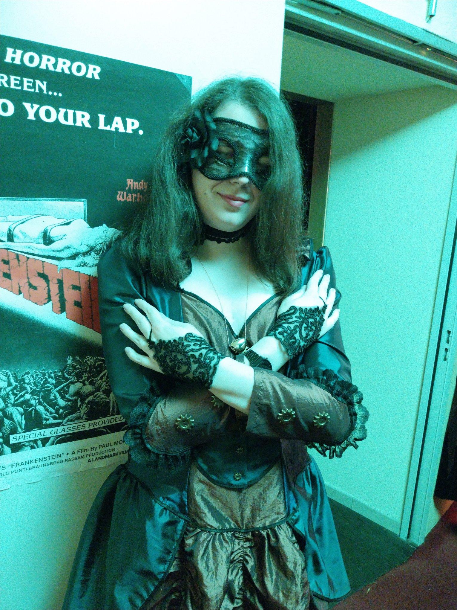 Selfie of me doing a crossing my arms over my shoulders
I wear a black translucent mask with stamps and a black rose on the right side, a purple choker with a rose on the left, a golden pendant "in a similar shape of a heart", a short translucent glove with patterns, a blue and maroon long dress, and outside the scope, long translucent stockings with rose patterns, and shoes Selfie of me doing a crossing my arms over my shoulders
I wear a black translucent mask with stamps and a black rose on the right side, a purple choker with a rose on the left, a golden pendant "in a similar shape of a heart", a short translucent glove with patterns, a blue and maroon long dress, and outside the scope, long translucent stockings with rose patterns, and shoes