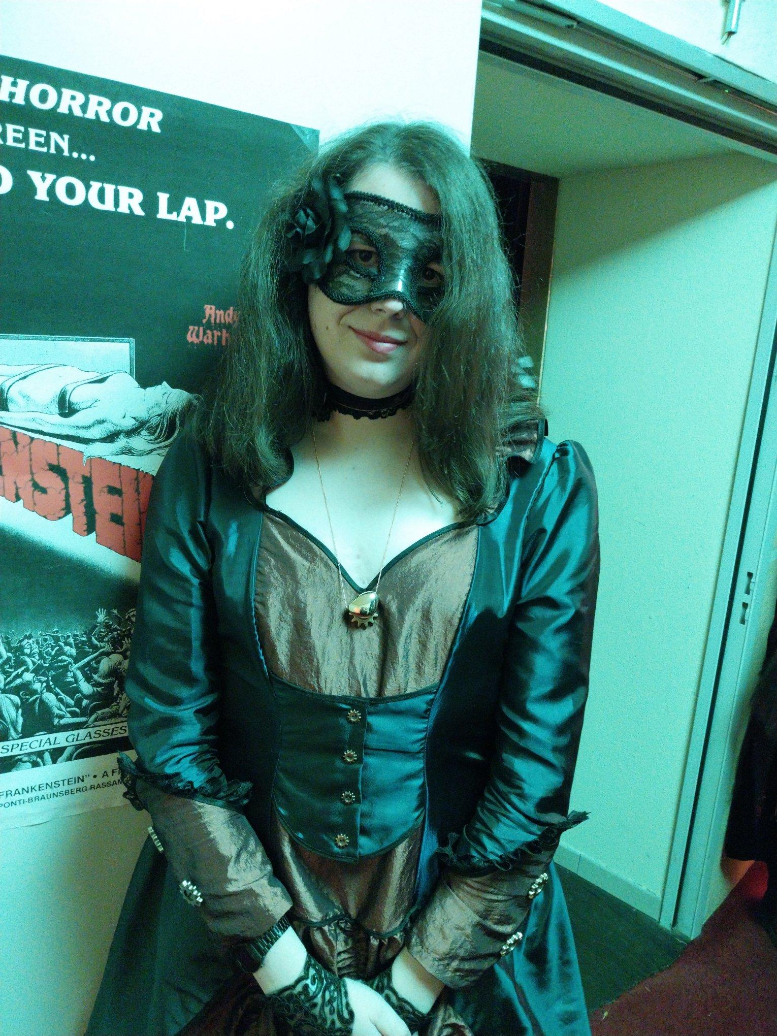 Selfie of me holding hands on the front
I wear a black translucent mask with stamps and a black rose on the right side, a purple choker with a rose on the left, a golden pendant "in a similar shape of a heart", a short translucent glove with patterns, a blue and maroon long dress, and outside the scope, long translucent stockings with rose patterns, and shoes Selfie of me holding hands on the front
I wear a black translucent mask with stamps and a black rose on the right side, a purple choker with a rose on the left, a golden pendant "in a similar shape of a heart", a short translucent glove with patterns, a blue and maroon long dress, and outside the scope, long translucent stockings with rose patterns, and shoes