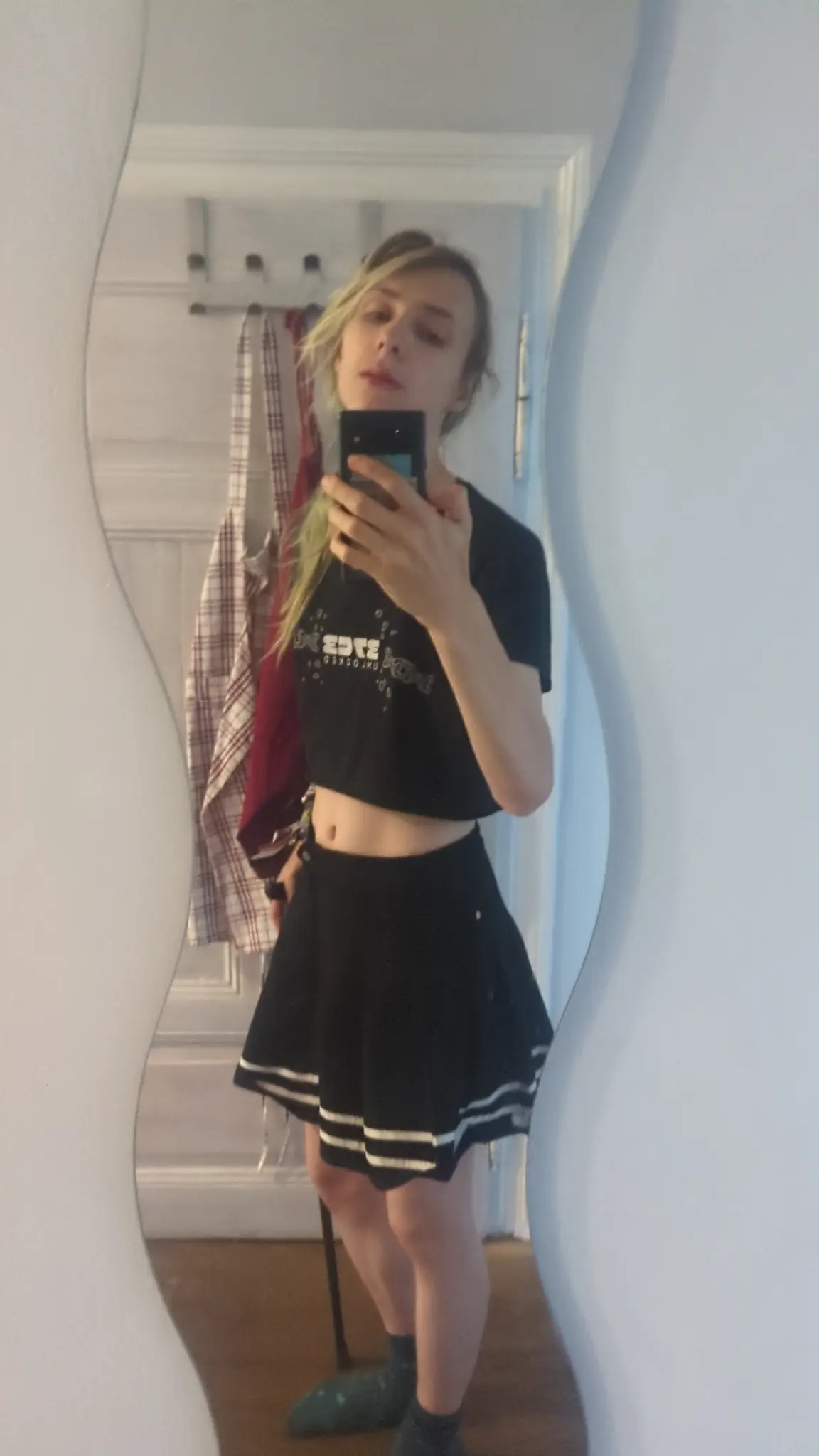 Picture of me wearing a black skirt with stripes , a cropped black 37c3 t-shirt.
It is leaning on it's cane